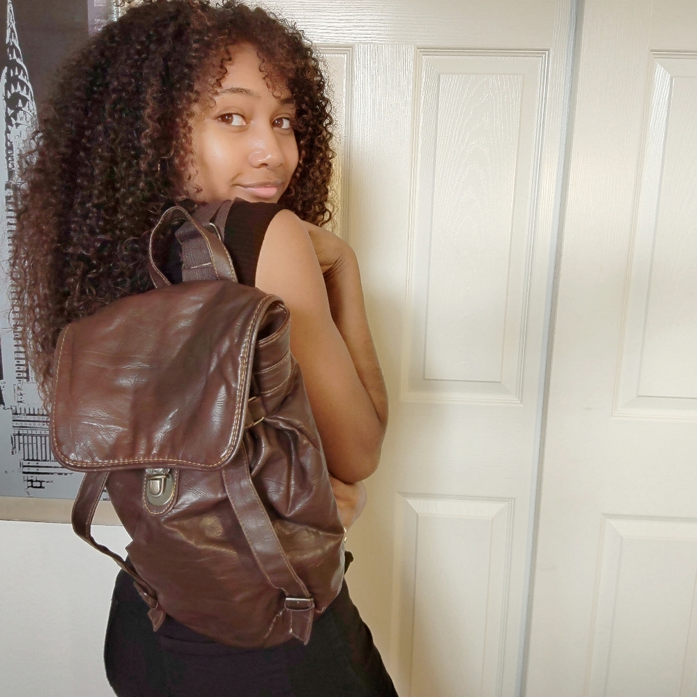 A dark brown backpack and a light brown one